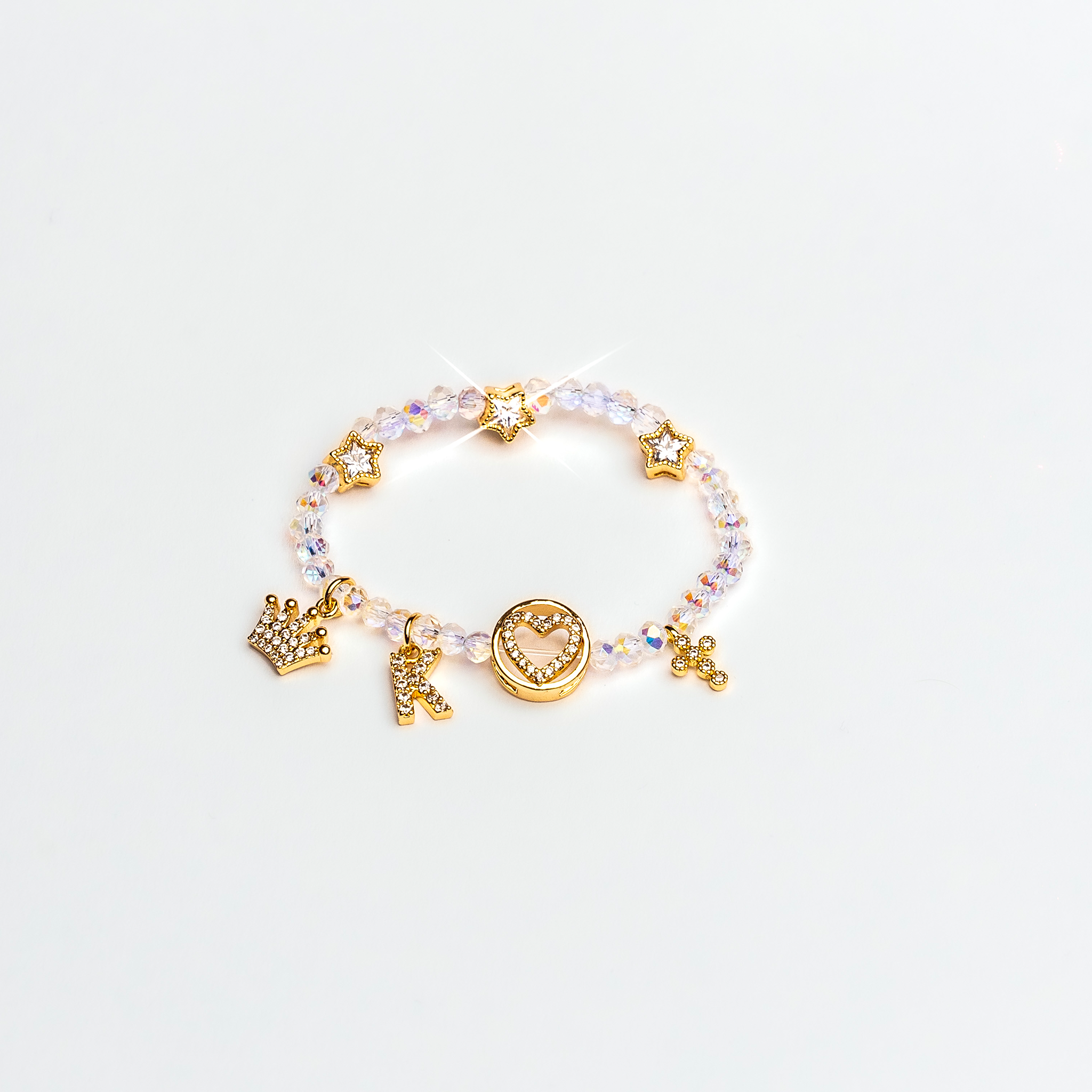 Zirconium bracelet with gold-platted charms